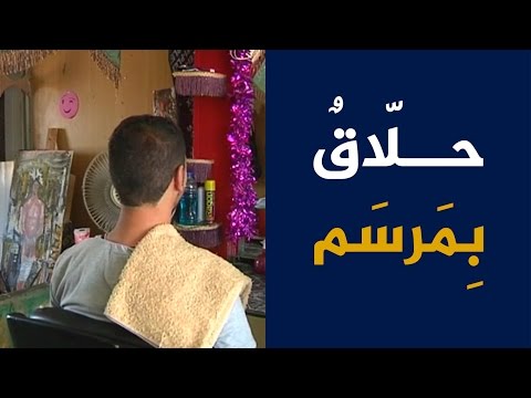 حلاق سوري داخل مرسم في مخيم الزعتري